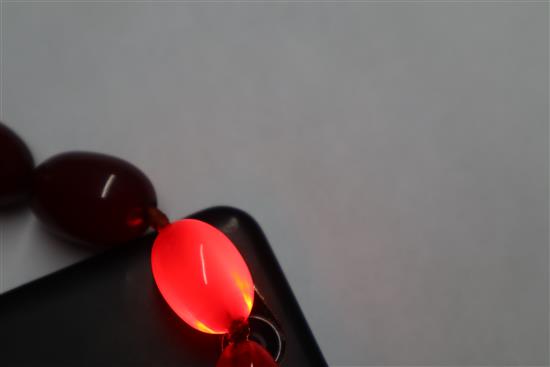 A single strand graduated simulated cherry amber necklace, gross weight, 114 grams, 82cm.